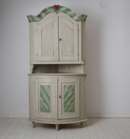 Antique Swedish corner cabinet made during the early 1800s. The cabinet is made in the transitional style where rococo became neoclassical