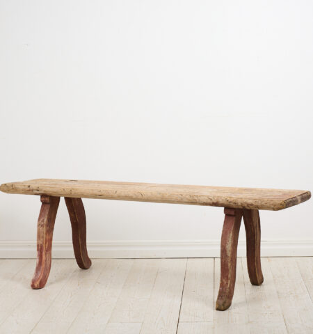 Rustic primitive antique bench in folk art from Northern Sweden. The bench is made by hand in solid pine and made around 1820