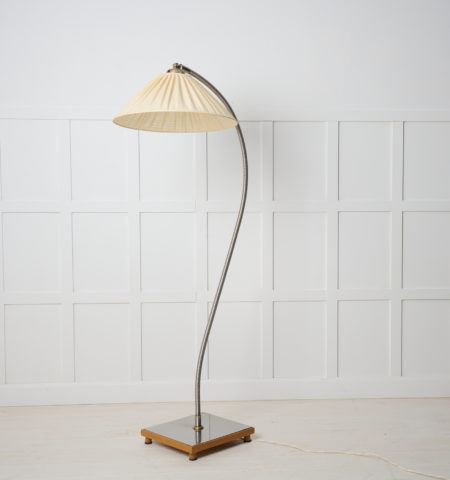 Swedish modern floor lamp in polished steel. The lamp is from around 1930 to 1940 and is made in Sweden. The lamp shade is original