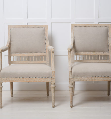 Genuine antique gustavian armchairs from Sweden made during the late 1700s. This pair of chairs have been scraped to the original paint