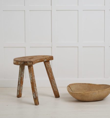 Charming folk art stool made by hand in solid pine. This stool has a primitive construction and organic shape with a cut out handle in the centre