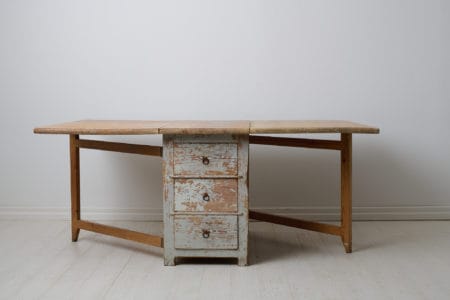 Antique drop leaf table made around 1840 to 1860 in northern Sweden. The table is a genuine country house furniture in a slightly unusual model with three drawers