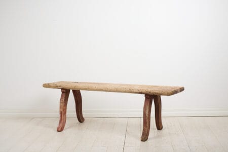 Rustic primitive antique bench in folk art from Northern Sweden. The bench is made by hand in solid pine and made around 1820