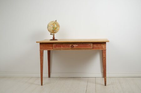 Antique Swedish rustic desk from the early 1800s. The desk is a large, classic country house furniture in gustavian style with straight tapered legs and a large drawer.