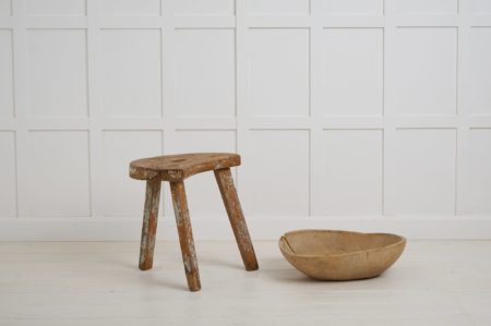 Charming folk art stool made by hand in solid pine. This stool has a primitive construction and organic shape with a cut out handle in the centre